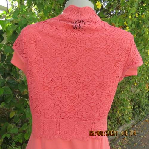 Lovely coral colour capped sleeve bolero in stretch acrylic lace. Size 34/10 by FASHION EXPRESS.