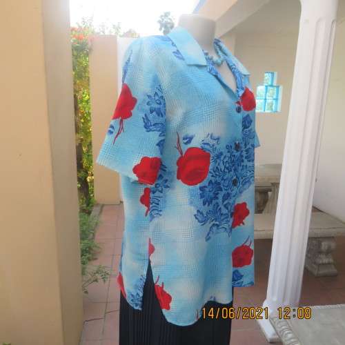 As new cheerful short sleeve top in blue floral pattern and red roses. Button down.Size 40/16.