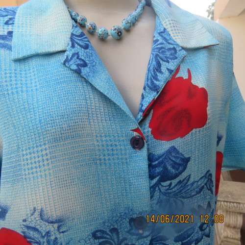 As new cheerful short sleeve top in blue floral pattern and red roses. Button down.Size 40/16.