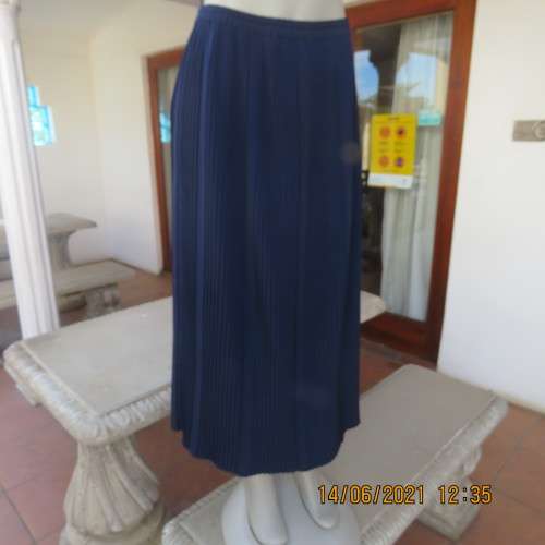 Smart permanent pleated navy 100% polyester calf length skirt with elasticated waist.Size 36/12.