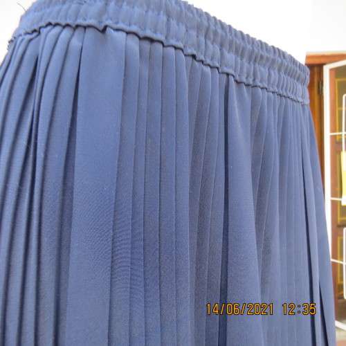 Smart permanent pleated navy 100% polyester calf length skirt with elasticated waist.Size 36/12.