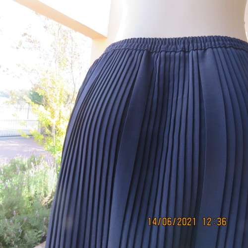 Smart permanent pleated navy 100% polyester calf length skirt with elasticated waist.Size 36/12.