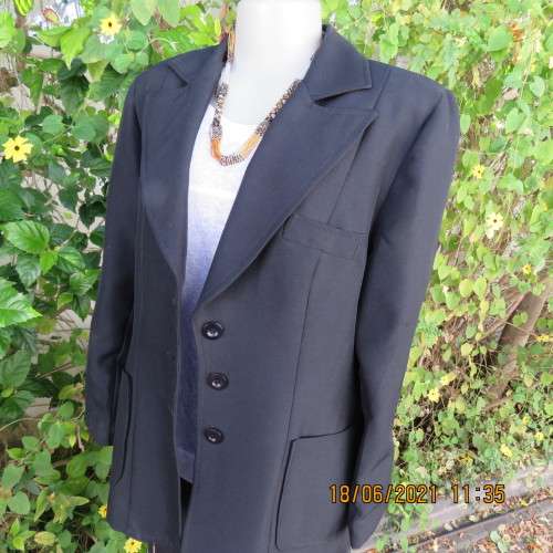 Blazer style black fully lined long sleeve jacket.With 3 front pockets. Size 36 to 38. Heavy poly.
