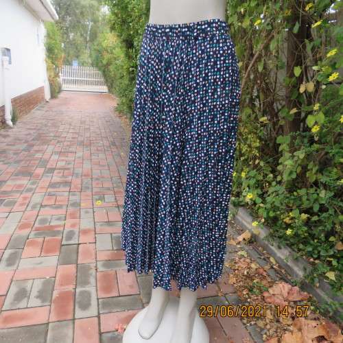 As new half flare permanent pleated navy ankle length skirt with jade/white/cream dots..Size 42/18.