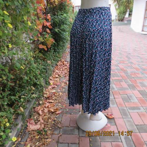 As new half flare permanent pleated navy ankle length skirt with jade/white/cream dots..Size 42/18.