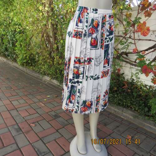 Eighty something permanent knife pleated skirt. White with navy/green/orange/red floral design.42/18
