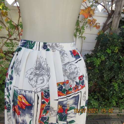 Eighty something permanent knife pleated skirt. White with navy/green/orange/red floral design.42/18