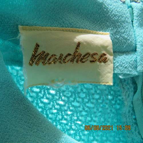 High quality vintage dress by MARCHESA from DELSWA size 42/18 in aquamarine crimplene.As new