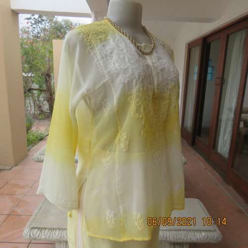 Sheer embellished polyester paneled slip over yellow top. Size 36/12. Three button opening.As new
