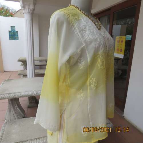 Sheer embellished polyester paneled slip over yellow top. Size 36/12. Three button opening.As new