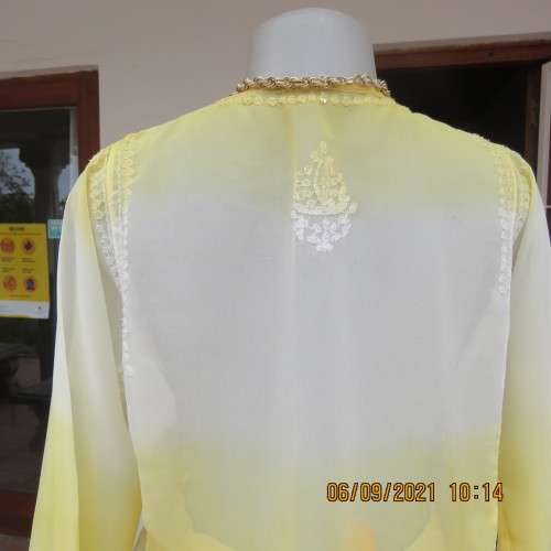 Sheer embellished polyester paneled slip over yellow top. Size 36/12. Three button opening.As new