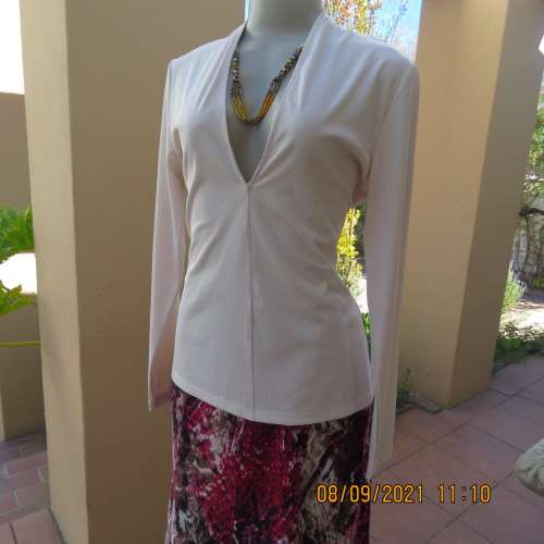 Top of the line rich cream long sleeve sexy top by H+M size 36/12. Made in Turkey. In new condition.
