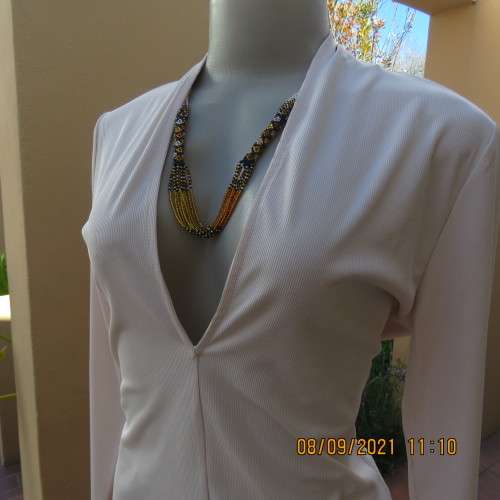Top of the line rich cream long sleeve sexy top by H+M size 36/12. Made in Turkey. In new condition.