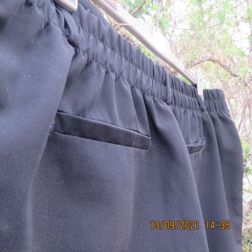 Smart black pants by PENNY C size 48/24. In polyester stretch fabric. Wide legs with some tapering.