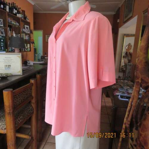 Summer fresh paw-paw colour button down top. Size 42/18. In 100% wash+wear polyester fabric. As new