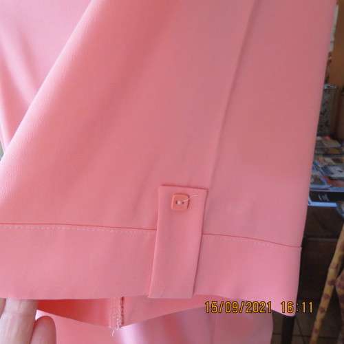 Summer fresh paw-paw colour button down top. Size 42/18. In 100% wash+wear polyester fabric. As new