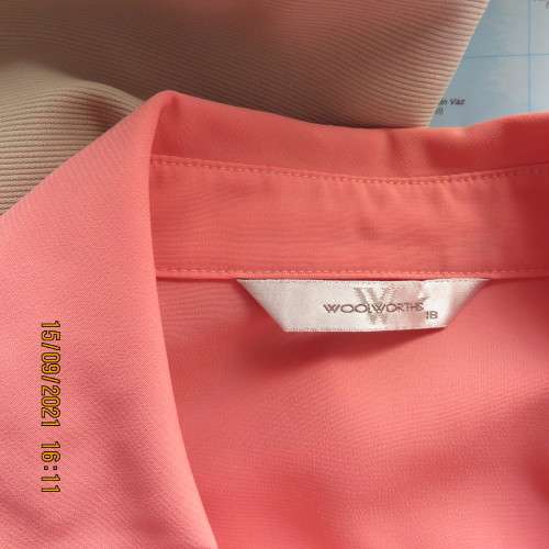 Summer fresh paw-paw colour button down top. Size 42/18. In 100% wash+wear polyester fabric. As new