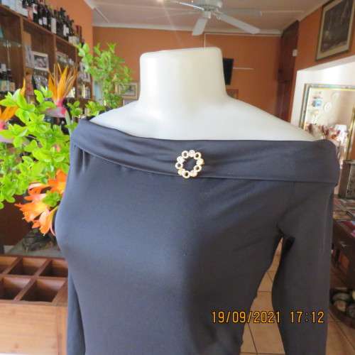 Hot black off the shoulder top by H+M size 32/8. Fold over collar. Poly stretch fabric. As new.