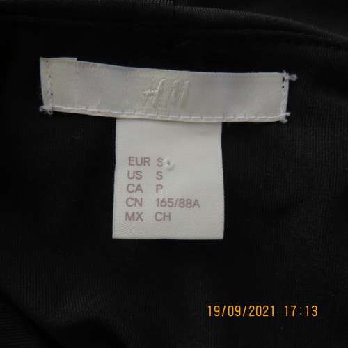 Hot black off the shoulder top by H+M size 32/8. Fold over collar. Poly stretch fabric. As new.