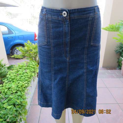 As new knee length denim skirt with 10 panels size 38/14. Zip on front. In polycotton stretch fabric