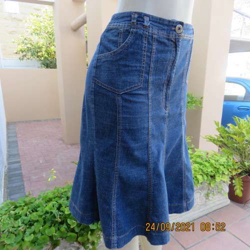As new knee length denim skirt with 10 panels size 38/14. Zip on front. In polycotton stretch fabric