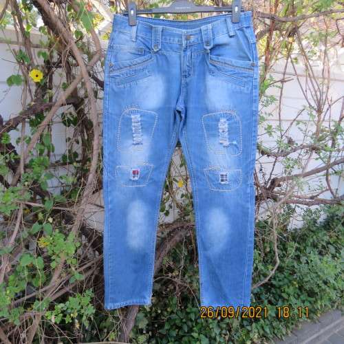 Men`s fashion blue distressed jeans with unique pockets galore size 34 by COSITA.Good condition.