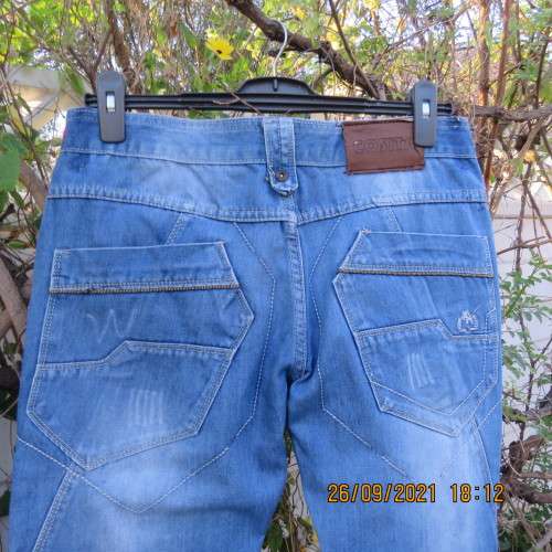 Men`s fashion blue distressed jeans with unique pockets galore size 34 by COSITA.Good condition.