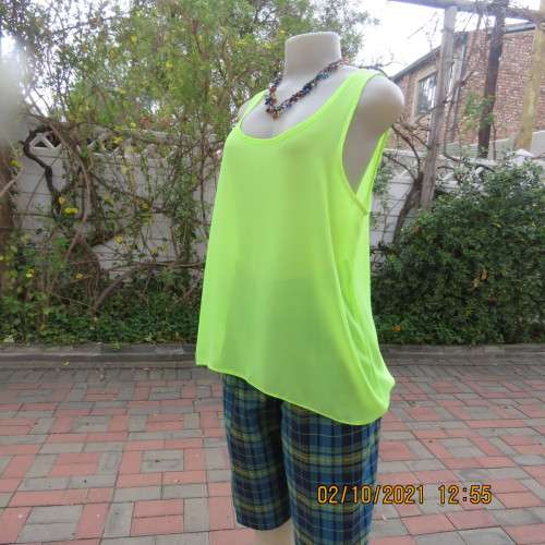 Sheer neon yellowgreen loose hanging sleeveless top. Slip over with scooped neckline. Size 38/14.