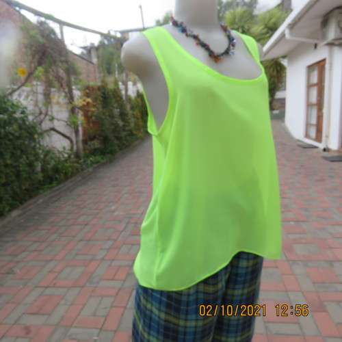 Sheer neon yellowgreen loose hanging sleeveless top. Slip over with scooped neckline. Size 38/14.