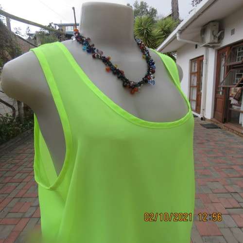 Sheer neon yellowgreen loose hanging sleeveless top. Slip over with scooped neckline. Size 38/14.
