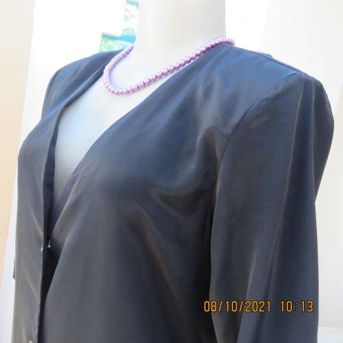 Elegant tailored black silky,shiny top/jacket. V neck,short sleeves and button down.Size 36 from UK.