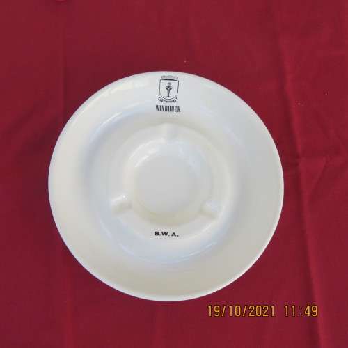 As new vintage large white porcelain ashtray from Windhoek S W A with badge.21cm diameter.About 30yr