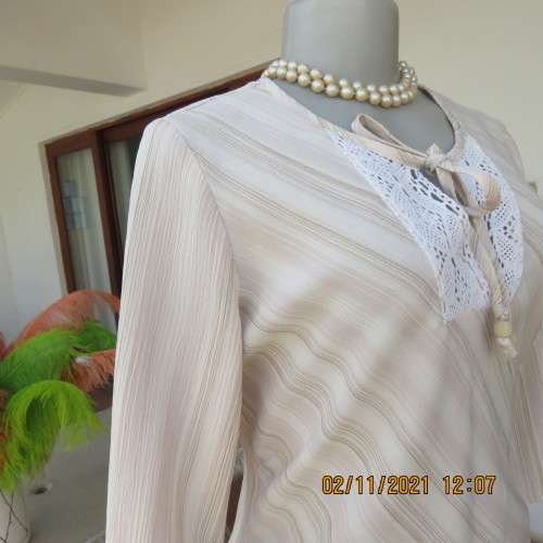 High quality slip over beige top by NEWS size 34/10 in diagonal stripes.In textured polyester/rayon