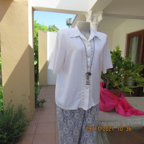 Beautiful short sleeve button down white top with cotton lace both sides.Size 36/12.Shirt collar.