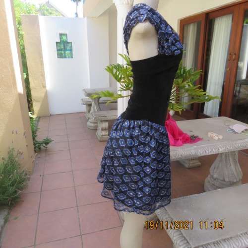 Youthful black velvet dropped waist dress. Acrylic lace,blue,gold skirt and shoulders.Size32 byOTT