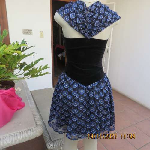 Youthful black velvet dropped waist dress. Acrylic lace,blue,gold skirt and shoulders.Size32 byOTT