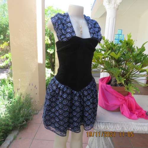 Youthful black velvet dropped waist dress. Acrylic lace,blue,gold skirt and shoulders.Size32 byOTT