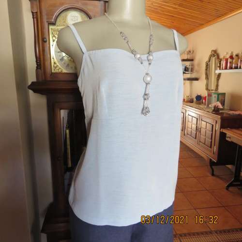 Powder blue empire style strappy top size 34/10 loose fit top in polyester satin.Owner made.As new
