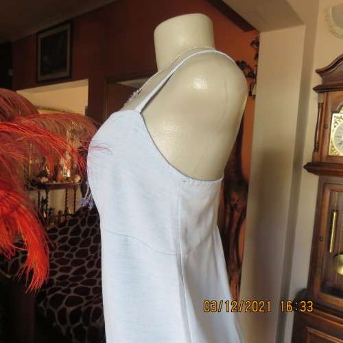 Powder blue empire style strappy top size 34/10 loose fit top in polyester satin.Owner made.As new