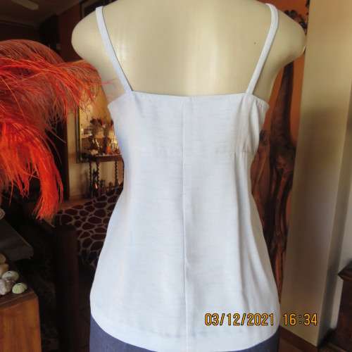Powder blue empire style strappy top size 34/10 loose fit top in polyester satin.Owner made.As new