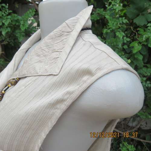 Cool sleeveless wheat colour button down top with open collar.Two small pockets.Size 36/12 . As new.