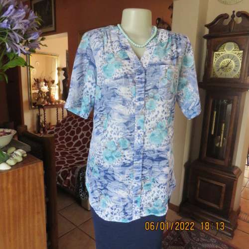 Exquisite 100% rayon CUPID short sleeve top in medley of blues and turquoise.Button down.New cond.
