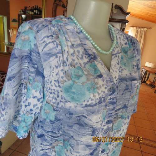 Exquisite 100% rayon CUPID short sleeve top in medley of blues and turquoise.Button down.New cond.