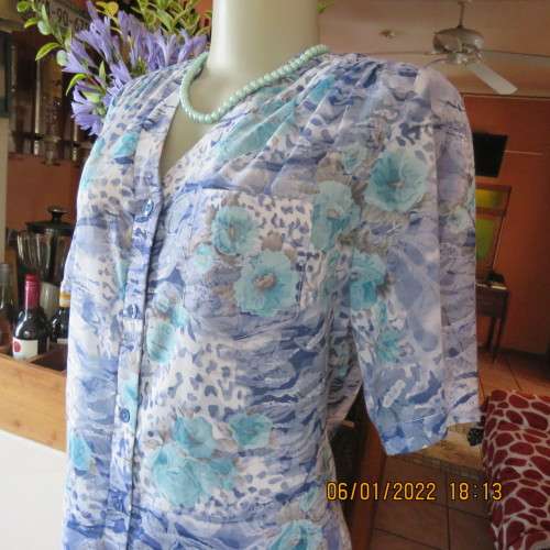 Exquisite 100% rayon CUPID short sleeve top in medley of blues and turquoise.Button down.New cond.