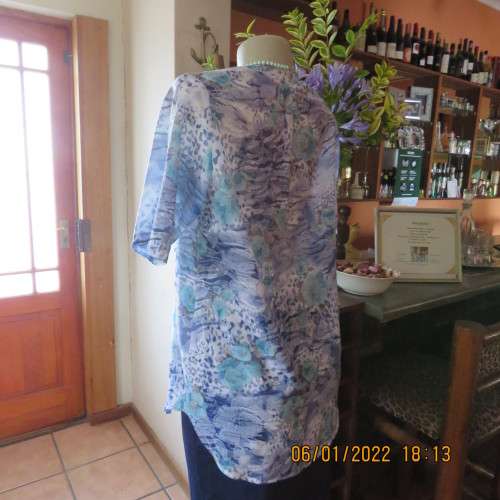 Exquisite 100% rayon CUPID short sleeve top in medley of blues and turquoise.Button down.New cond.