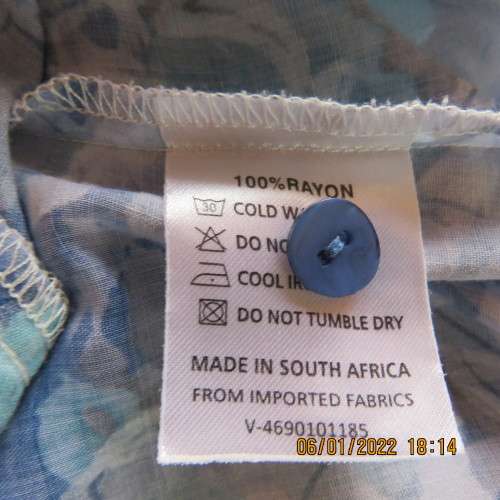 Exquisite 100% rayon CUPID short sleeve top in medley of blues and turquoise.Button down.New cond.