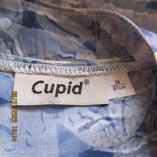 Exquisite 100% rayon CUPID short sleeve top in medley of blues and turquoise.Button down.New cond.