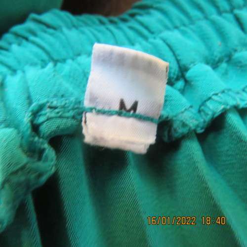 Emerald green permanent pleated flare skirt size 36 to 38. 100% polyester. Elasticated waist. As new