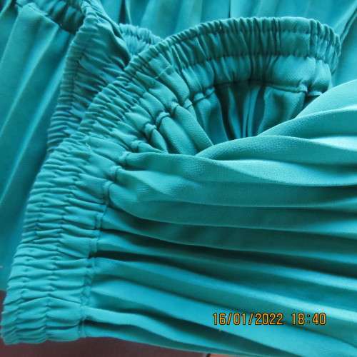 Emerald green permanent pleated flare skirt size 36 to 38. 100% polyester. Elasticated waist. As new
