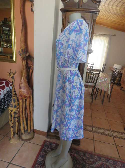 Cool owner made white polyester princess style dress with lilac/blue graphic print.Size 40/16.As new
